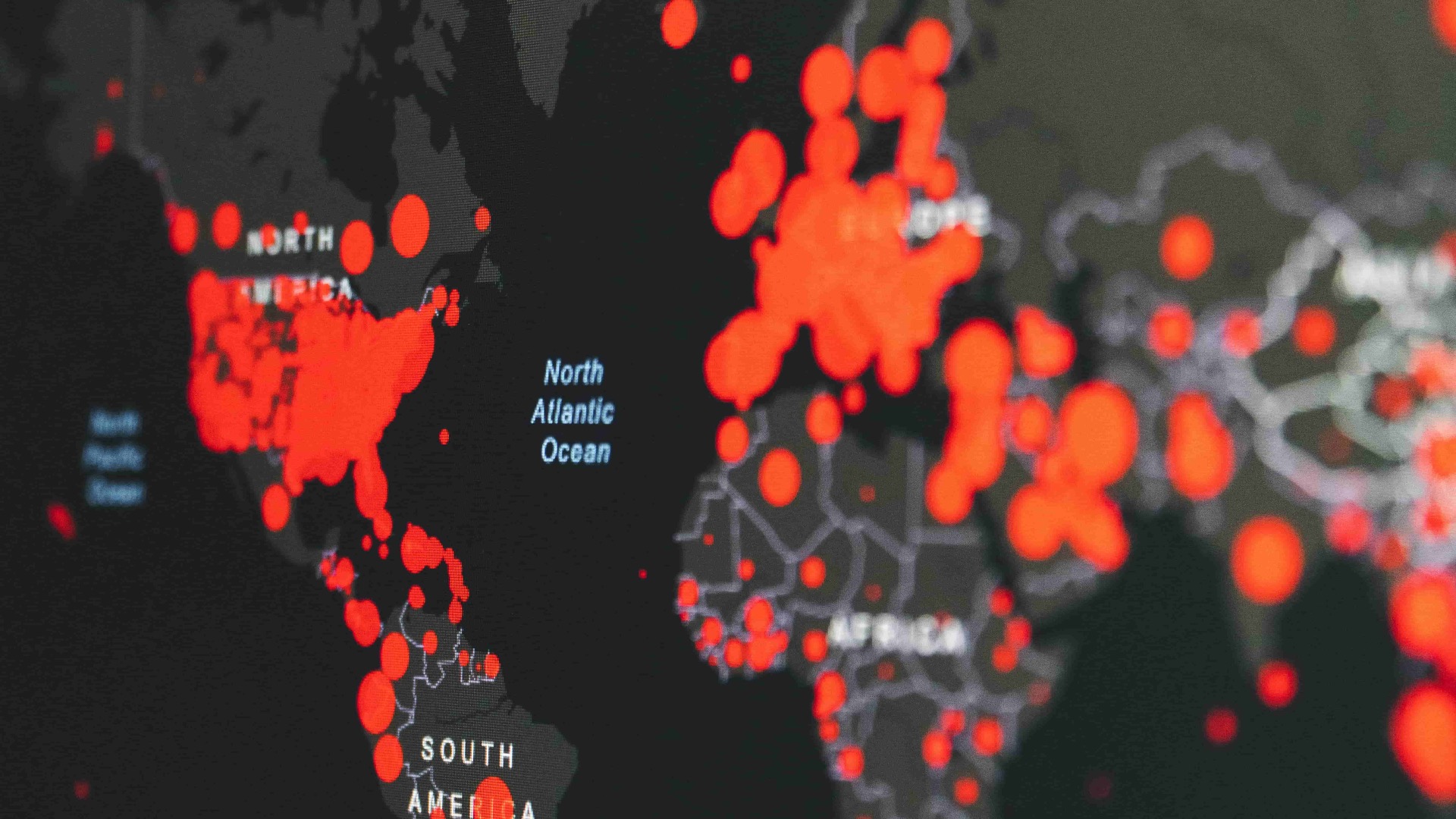 A world map with red dots on top of countries representing their proportion of pandemic cases